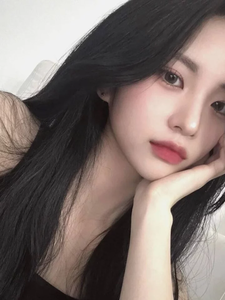 Professional portrait of Jiyoung in soft lighting, wearing neutral-toned attire Professional portrait of Jiyoung in soft lighting, wearing neutral-toned attire